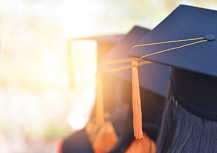 line of students in graduation cap and gown